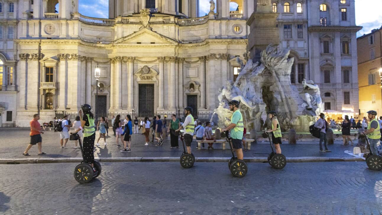 A group rides through Navona Square on Segways in Rome, Italy