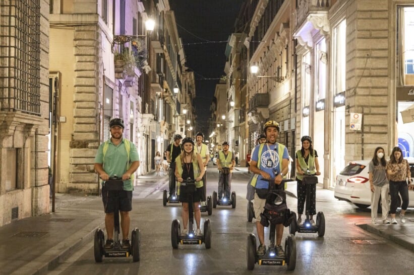 A group on Segways rides through the streets of Rome, Italy