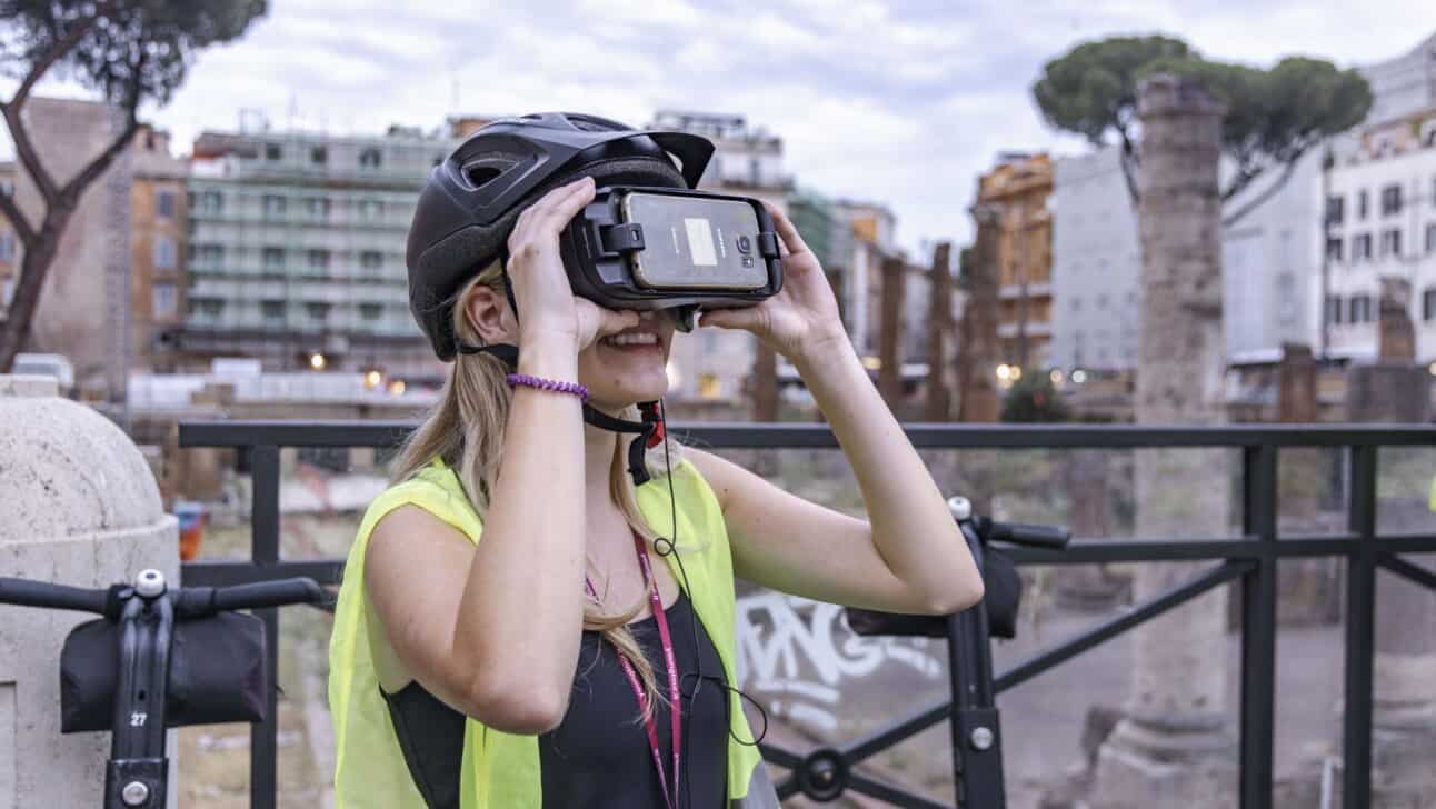A women uses a VR headset to experience ancient Rome