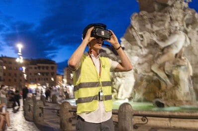 A man drops his jaw in wonderment while using a VR headset in Rome, Italy