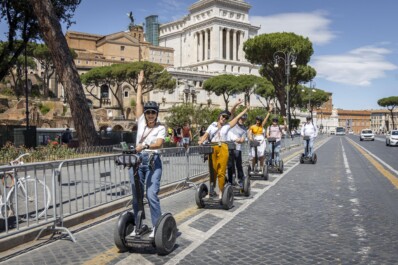 A group of Segwayers ride through central Rome