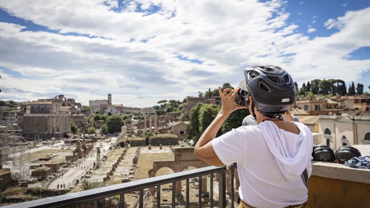 A woman uses a VR headset to experience ancient Rome