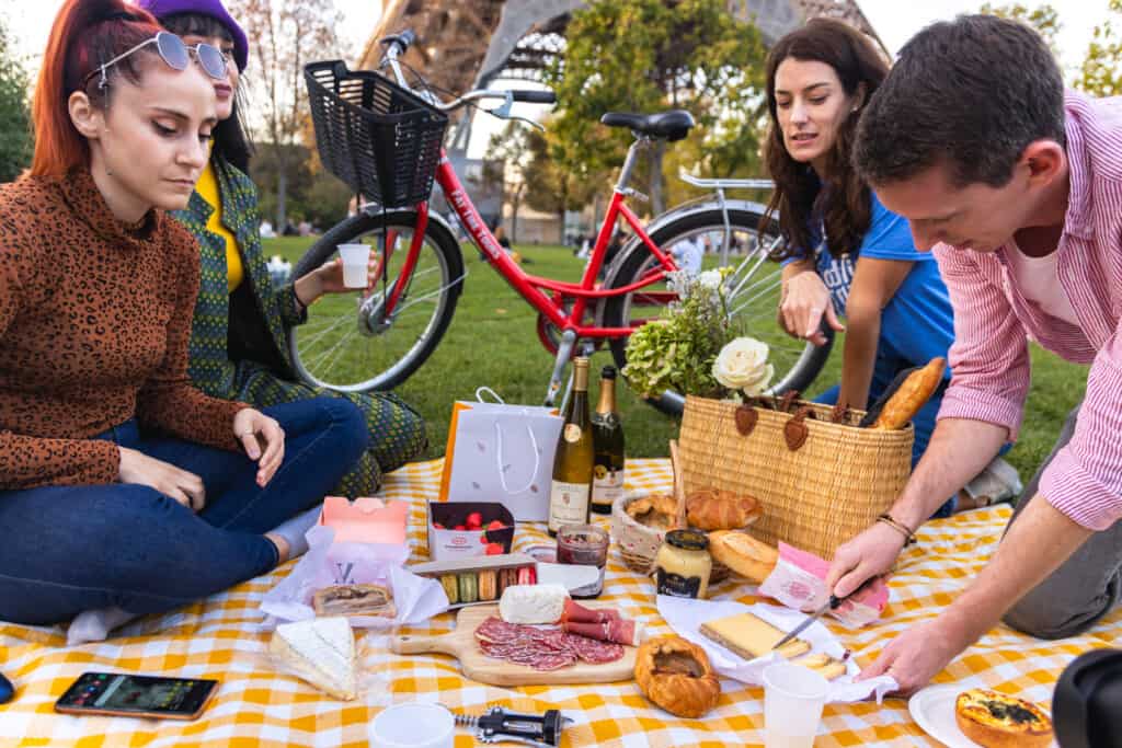 Group of people have picnic at the Eiffel Tower