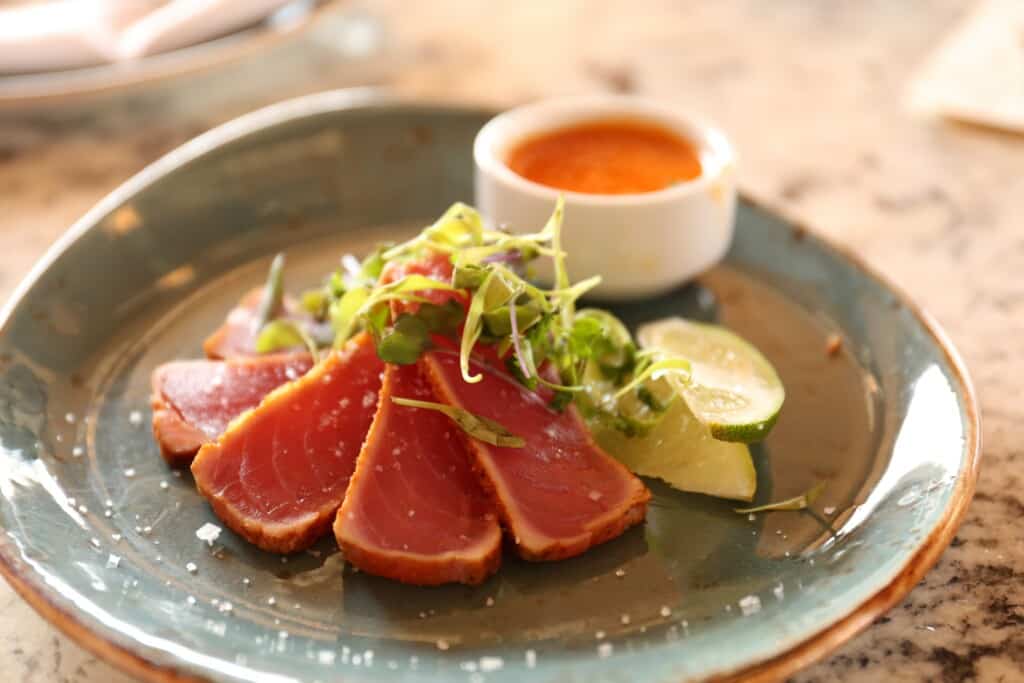 Thinly sliced tuna with a a salad and sauce