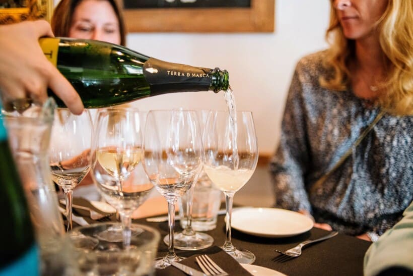 Champagne being poured at a table in Paris, France