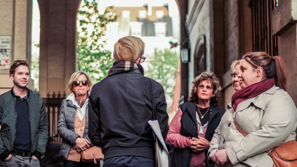 A guide speaking to a group in the Latin Quarter in Paris, France