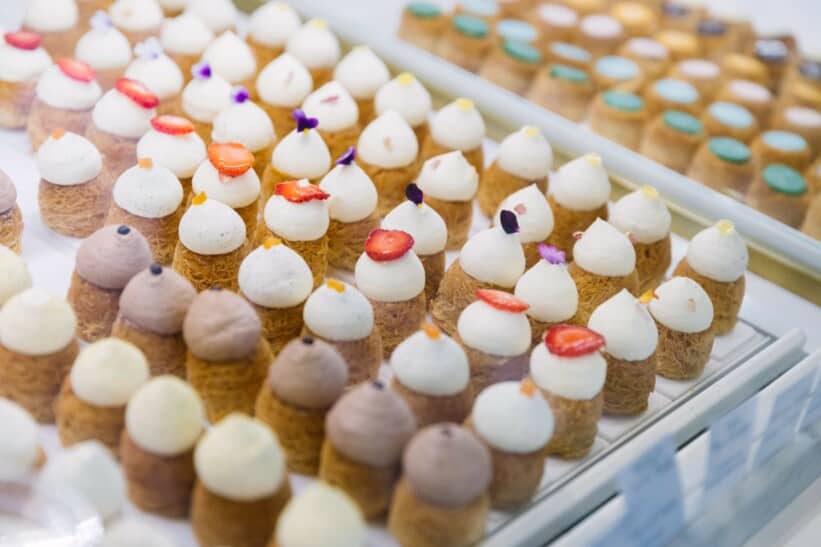 dome-shaped desserts on display in a bakery window