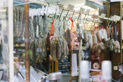 Saucissions sec hanging in a butcher's window in Paris, France