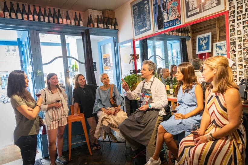 Six women enjoy a wine tasting and explanation in Paris, France