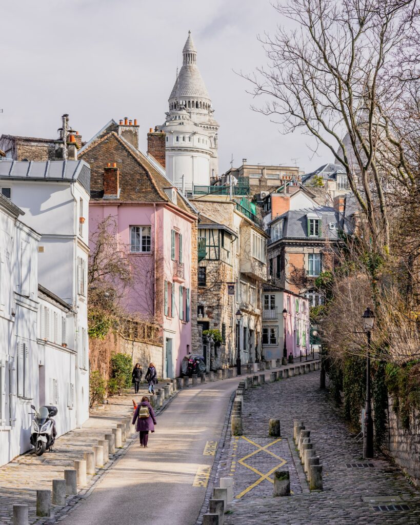 A winding street in Montmartre, Paris lined with colorful houses