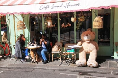 Friends enjoy hot beverages at the Café Saint Honoré in Paris, France