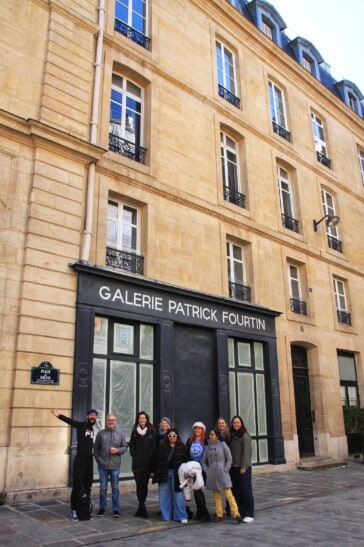 A group of tourists take a picture in front of the art gallery by Patrick Fourtin