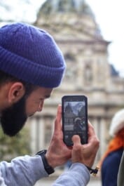 A tourist takes a picture of his tour guide in Paris, France