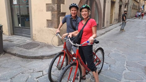 A couple pose with their bikes in Florence, Italy