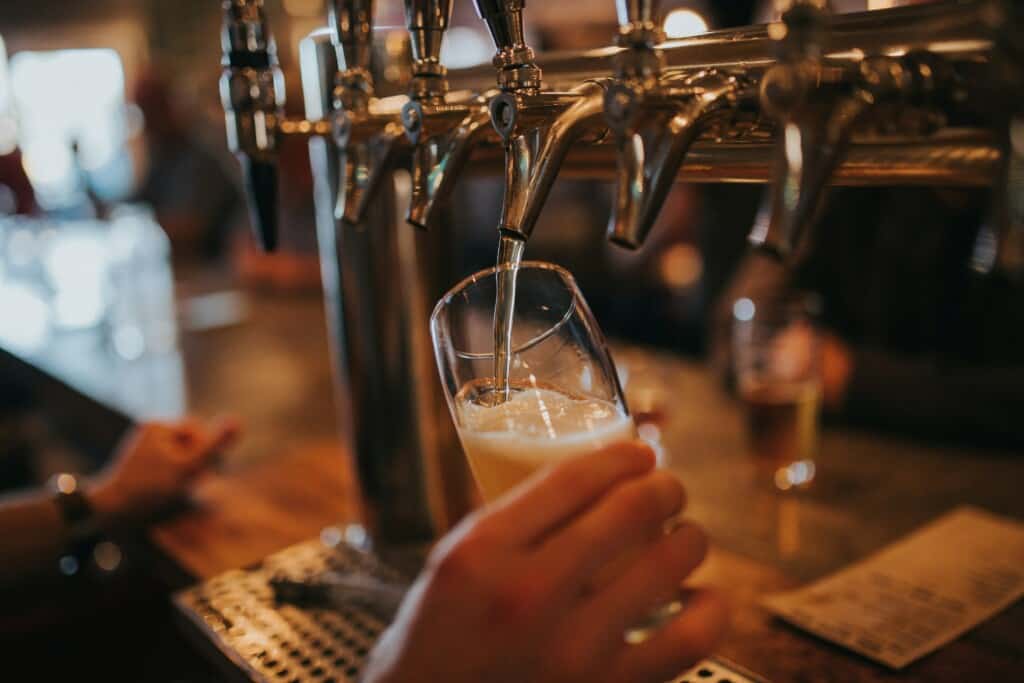 A barman pours a pint in a bar on st. patrick's day