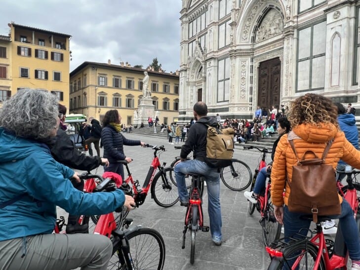 a group of cyclists one-bikes learn about the Duomo in Florence, Italy