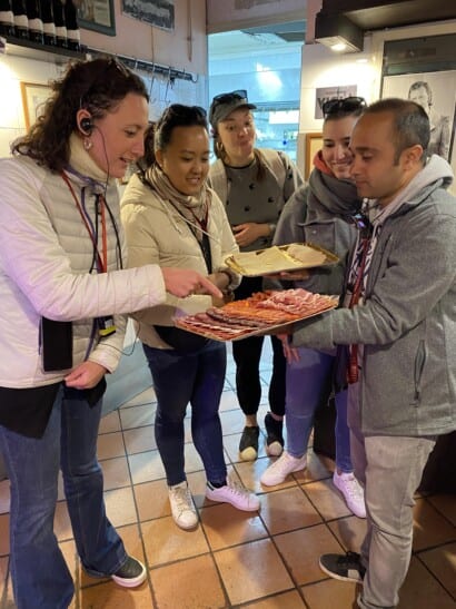 4 women sample Italian meat and cheese