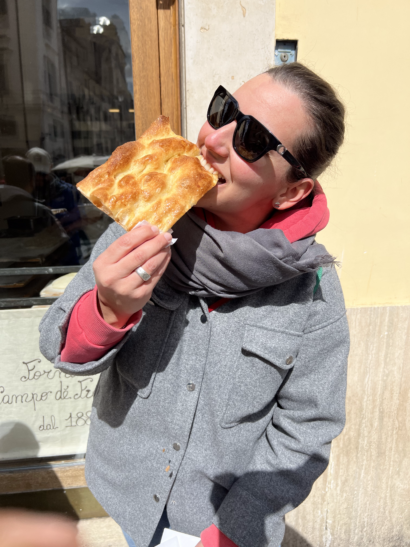A women enjoys authentic Italian pizza in Rome