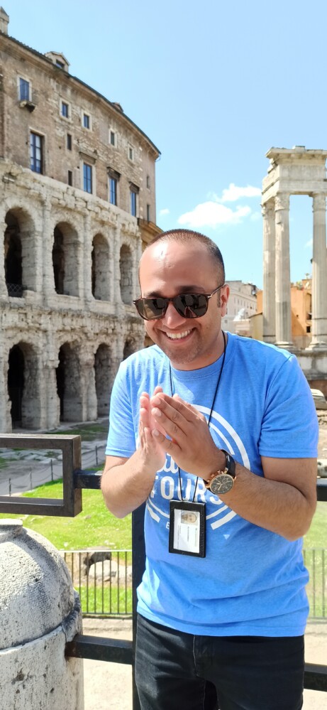 A smiling man in a blue t-shirt