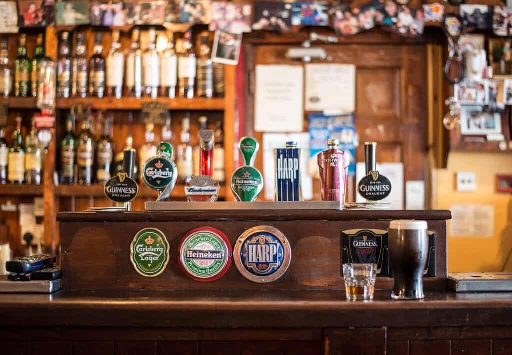 Various beers on draft inside a London pub