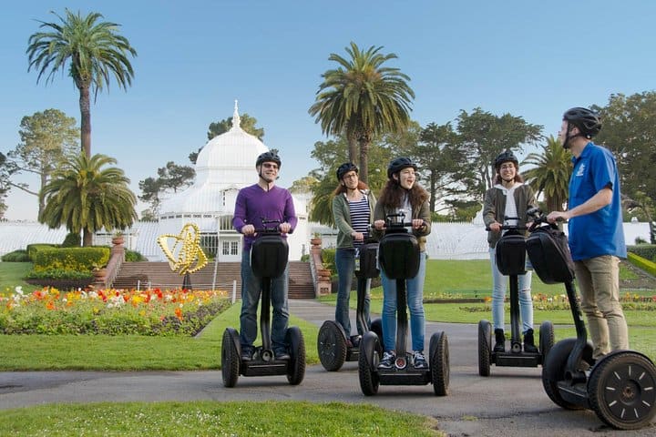 A group of Segway riders in front of the Conservatory of Flowers in San Francisco's Golden Gate Park