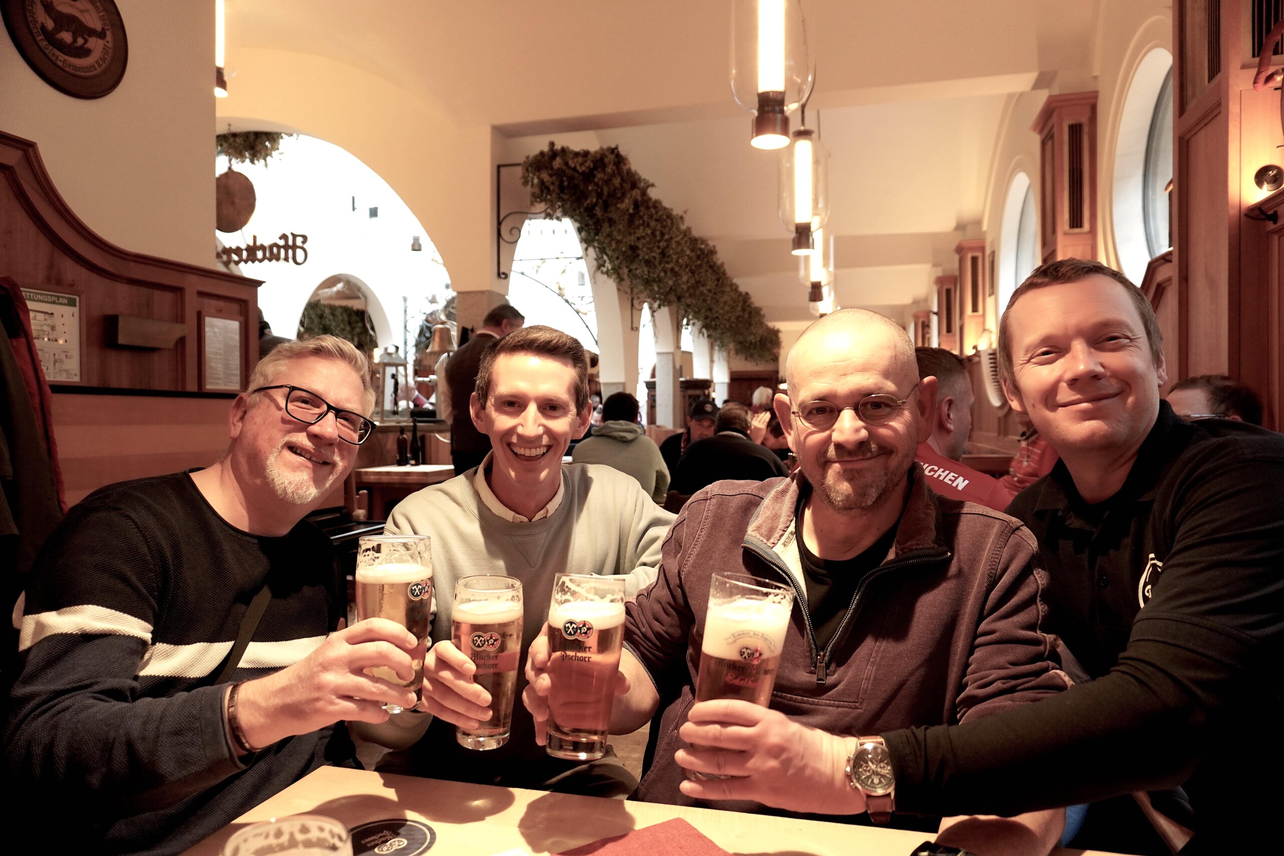 Four men cheers at the Hacker-Pschorr House in Munich