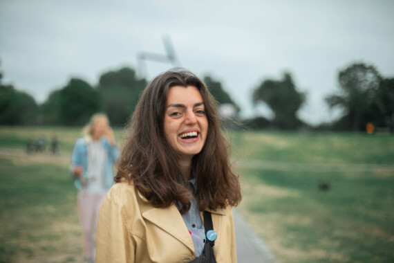 A woman smiling in a field