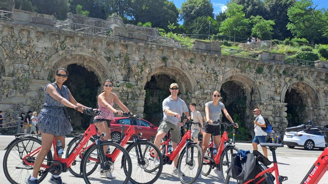 A group of 4 poses for a picture on red e-bikes in Florence