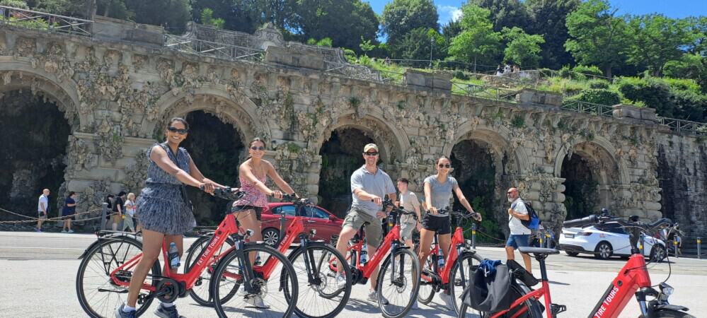 A group of 4 poses for a picture on red e-bikes in Florence