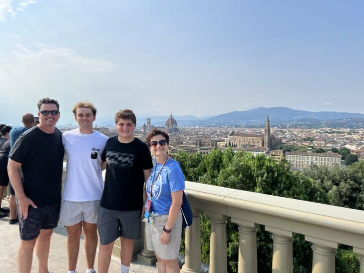A group smiles for a photo at Piazzale Michelangelo