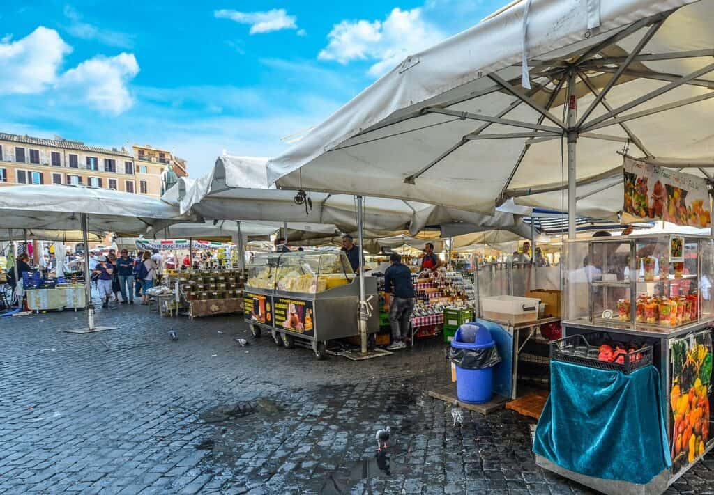 Vendors at Campo De Fiori market sell products from their stalls