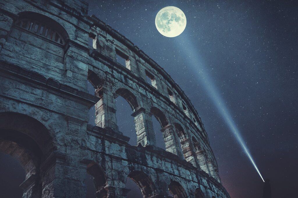 The Colosseum at night with a full moon overhead and stars in the background