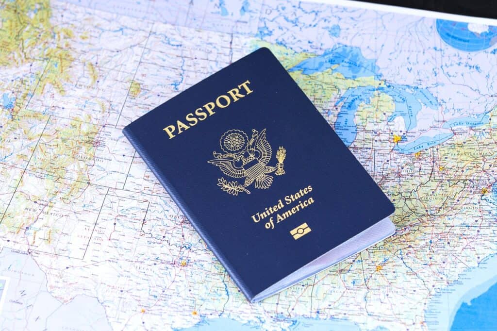 A U.S.A  passport sitting on top of a map