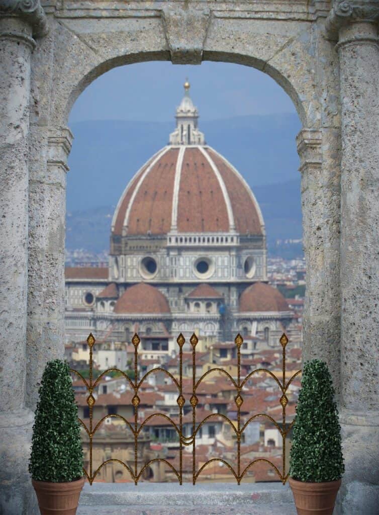 The Duomo pictured through a gray stone archway