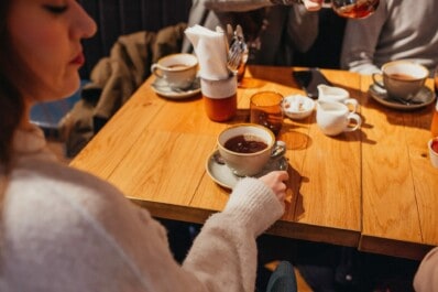 A woman enjoys a cup of coffee