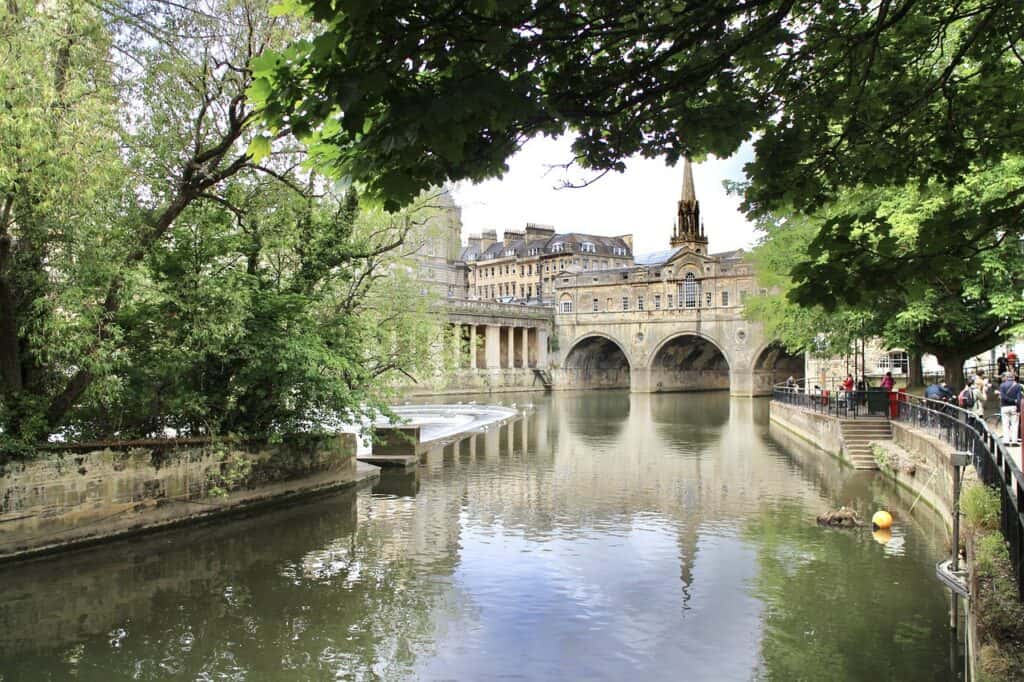 A view of the river in Bath, England with trees hanging overhead