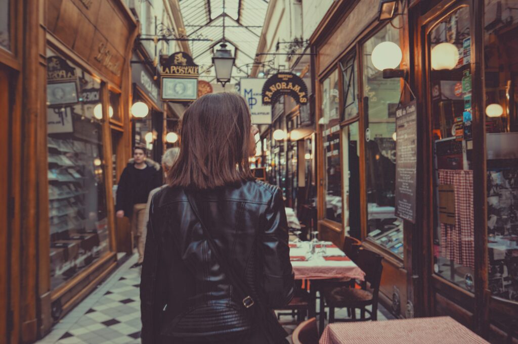 a woman strolls through the passage des panoramas in Paris, France