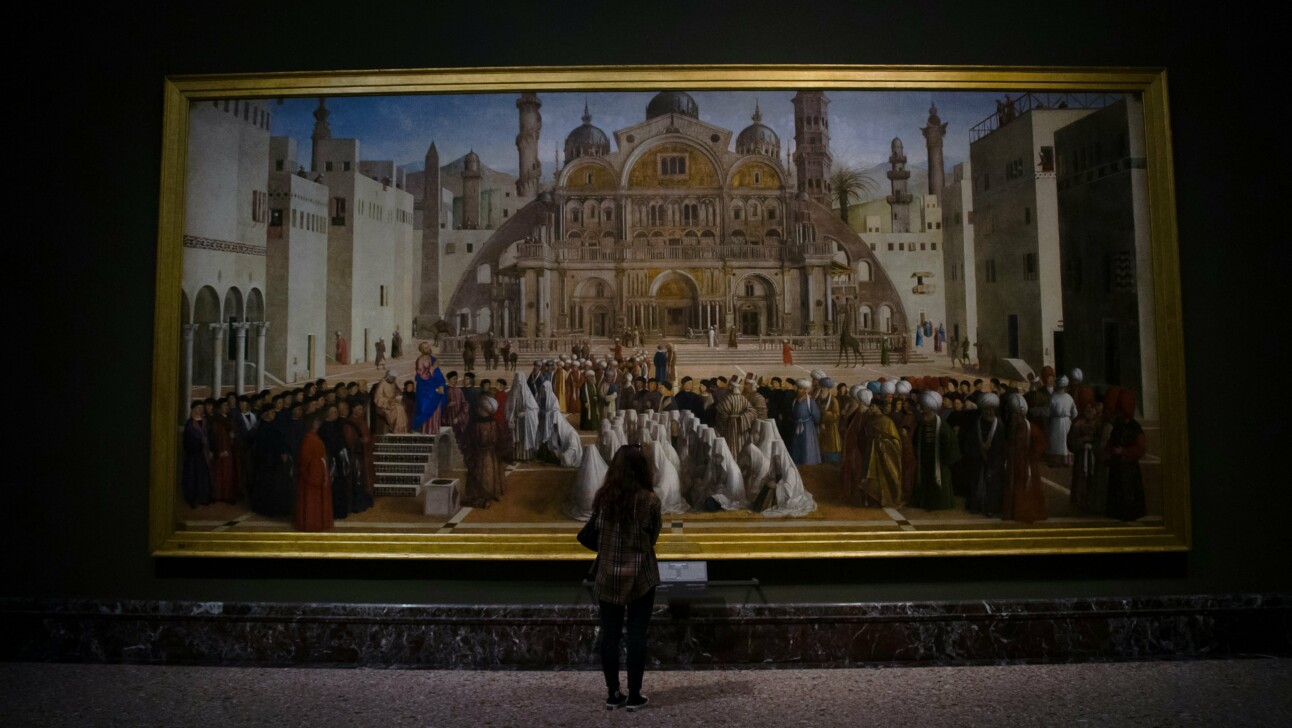 A woman marvels at a painting inside the Pinacoteca Ambrosiana in Milan, Italy