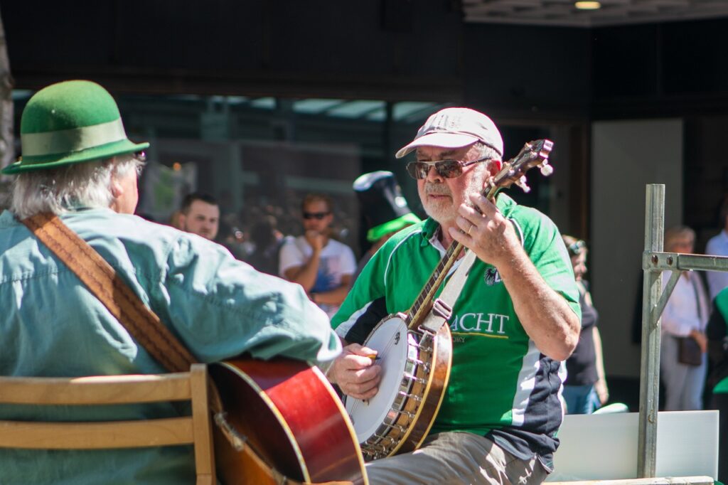Musicians in green shirts play at a St. Patrick's Day Celebration