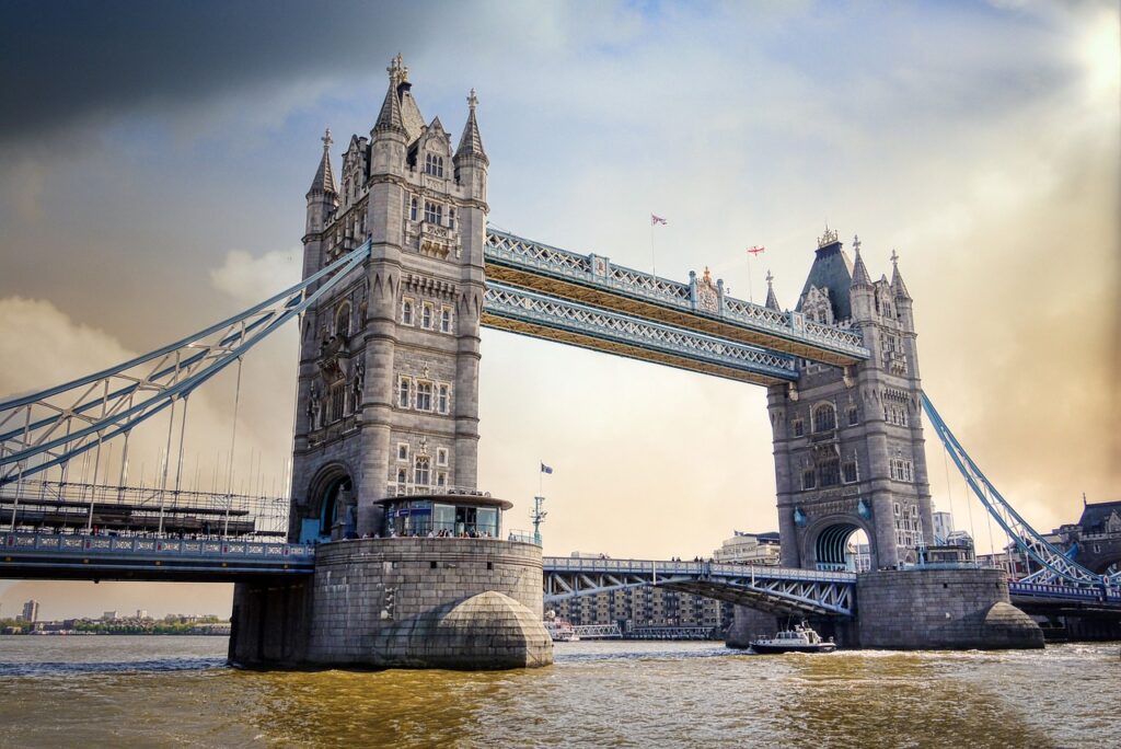 Tower Bridge in London on a sunny day with a blue sky and the Thames River beneath the bridge